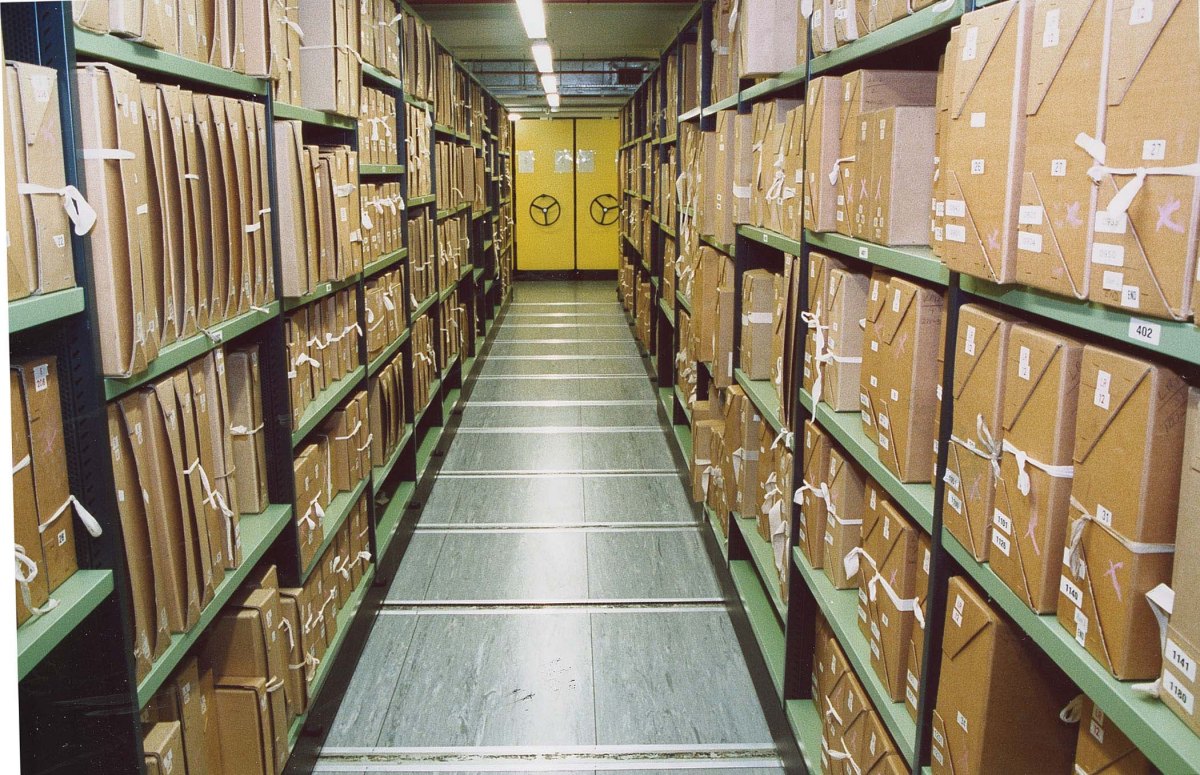 Stacks of archived documents on shelves